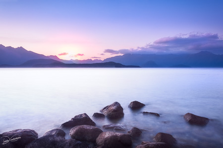 Wonderful sunset at Lake Te Anau - long exposure with rocks in water