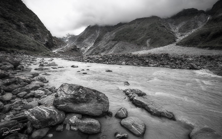 Dramatic perspective view in black and white from the Waiho River in New Zealand